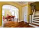 Entryway shows dining room, staircase, hardwood floors, archway, and elegant chandelier at 50 Rumson Ne Way, Atlanta, GA 30305