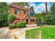 Charming brick home featuring lush landscaping, a stone pathway, and manicured lawn at 50 Rumson Ne Way, Atlanta, GA 30305