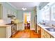Well-lit kitchen with stainless steel appliances, terracotta tile floors, and ample counter space at 50 Rumson Ne Way, Atlanta, GA 30305