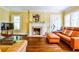 Cozy living room featuring hardwood floors, fireplace, bright windows, and comfortable seating at 50 Rumson Ne Way, Atlanta, GA 30305