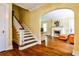 View of the hardwood floors, staircase, fireplace, and doorway into the living room at 50 Rumson Ne Way, Atlanta, GA 30305