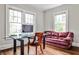 Office area with modern glass desk, leather sofa, hardwood floors and abundant natural light at 50 Rumson Ne Way, Atlanta, GA 30305