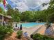 Spacious pool area with blue umbrellas and lounge chairs providing a relaxing and enjoyable community space at 50 Rumson Ne Way, Atlanta, GA 30305