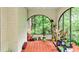 Sunroom with lots of natural light, tile floors, and arched windows showcasing the surrounding greenery at 50 Rumson Ne Way, Atlanta, GA 30305