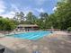 Large community swimming pool with lap lanes, diving board, and ample lounge seating for residents' enjoyment at 50 Rumson Ne Way, Atlanta, GA 30305