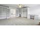 Carpeted bonus room with built-in bookcases, cabinets, and desks at 2922 Heart Pine Way, Buford, GA 30519