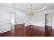 Elegant dining area featuring gleaming hardwood floors and a stylish chandelier at 2922 Heart Pine Way, Buford, GA 30519