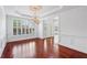 Formal dining room boasting hardwood floors, large window, and elegant chandelier at 2922 Heart Pine Way, Buford, GA 30519