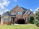 Beautiful brick two-story home with manicured lawn, dark shutters, and well-maintained landscaping at 2922 Heart Pine Way, Buford, GA 30519