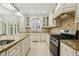Spacious kitchen features granite countertops, stainless steel appliances, and ample cabinetry at 2922 Heart Pine Way, Buford, GA 30519