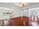 Open concept living room with hardwood floors, staircase, and an adjacent kitchen area at 2922 Heart Pine Way, Buford, GA 30519