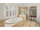 Bathroom features a soaking tub, a glass shower, and natural light at 2922 Heart Pine Way, Buford, GA 30519