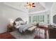 The main bedroom is furnished with neutral tones, hardwood floors, and bright natural light at 2922 Heart Pine Way, Buford, GA 30519