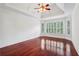 Main bedroom with hardwood floors, a ceiling fan, and plantation shutters at 2922 Heart Pine Way, Buford, GA 30519