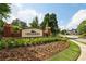 Landscaped entrance to the Hedgerows community with beautiful flowers at 2922 Heart Pine Way, Buford, GA 30519