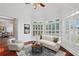 Bright sitting area with plantation shutters, hardwood floors, and comfortable seating at 2922 Heart Pine Way, Buford, GA 30519