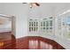 Bright sitting area featuring large windows with plantation shutters and gleaming hardwood floors at 2922 Heart Pine Way, Buford, GA 30519