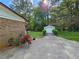 Charming brick home with a long driveway leading to a detached garage at 417 Ohern Ct, Stone Mountain, GA 30088