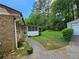 Charming brick home with a long driveway leading to a detached garage at 417 Ohern Ct, Stone Mountain, GA 30088