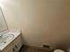 This bathroom features a white vanity with a sink and a wood-look floor at 417 Ohern Ct, Stone Mountain, GA 30088