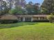 Charming brick home with a well-manicured lawn and mature trees in a quiet neighborhood at 417 Ohern Ct, Stone Mountain, GA 30088