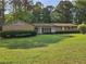 Charming brick home with a well-manicured lawn and mature trees in a quiet neighborhood at 417 Ohern Ct, Stone Mountain, GA 30088