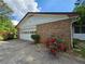 Attached brick garage with lush landscaping adding privacy and curb appeal at 417 Ohern Ct, Stone Mountain, GA 30088