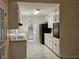 Bright kitchen features sleek appliances, white cabinets, and tiled flooring at 417 Ohern Ct, Stone Mountain, GA 30088
