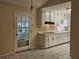 Functional kitchen with white cabinetry, bright lighting, and a doorway to the back at 417 Ohern Ct, Stone Mountain, GA 30088