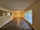 Spacious living room with hardwood floors, large windows, and ample natural light at 417 Ohern Ct, Stone Mountain, GA 30088