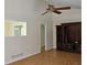 Bright living room featuring wood-look floors, a ceiling fan and paneled walls at 417 Ohern Ct, Stone Mountain, GA 30088