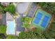 Aerial view of a community pool and tennis courts surrounded by lush greenery and parking spaces, ideal for recreation at 4294 Silver Peak Pkwy, Suwanee, GA 30024