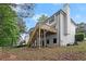 Backyard view featuring a wooden deck, fencing, and a well-maintained lawn at 4294 Silver Peak Pkwy, Suwanee, GA 30024