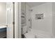 Stylish bathroom with a modern tub-shower combination featuring tiled walls and a convenient built-in niche at 4294 Silver Peak Pkwy, Suwanee, GA 30024