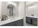 Well-lit bathroom showcasing dual vanities with elegant mirrors and fixtures, offering plenty of counter space at 4294 Silver Peak Pkwy, Suwanee, GA 30024