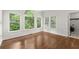 Dining room with hardwood floors, large windows, and access to laundry room at 4294 Silver Peak Pkwy, Suwanee, GA 30024