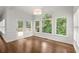 Dining room with hardwood floors, large windows, and access to outdoor deck at 4294 Silver Peak Pkwy, Suwanee, GA 30024