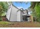 Exterior view of home with siding, wooded surroundings, and a deck at 4294 Silver Peak Pkwy, Suwanee, GA 30024