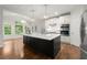 Bright kitchen with stainless steel appliances, a large island, and a vaulted ceiling at 4294 Silver Peak Pkwy, Suwanee, GA 30024