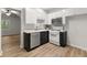 Well-equipped kitchen showcasing white cabinets, stainless steel appliances, and wood-look flooring at 4294 Silver Peak Pkwy, Suwanee, GA 30024