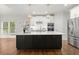 Bright kitchen with stainless steel appliances, a spacious island, and modern pendant lighting at 4294 Silver Peak Pkwy, Suwanee, GA 30024