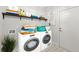 Modern laundry room featuring new machines, storage, and stylish flooring at 4294 Silver Peak Pkwy, Suwanee, GA 30024