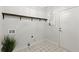 Laundry room with patterned tile floor, wooden shelf, and plenty of natural light at 4294 Silver Peak Pkwy, Suwanee, GA 30024