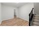 Living room featuring modern flooring and staircase with black metal handrail at 4294 Silver Peak Pkwy, Suwanee, GA 30024
