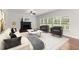 Bright living room featuring a fireplace, large windows, and comfortable seating arrangement at 4294 Silver Peak Pkwy, Suwanee, GA 30024