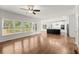 Open concept living room and kitchen with hardwood floors and plenty of natural light at 4294 Silver Peak Pkwy, Suwanee, GA 30024