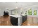 Open concept living room and kitchen with hardwood floors and plenty of natural light at 4294 Silver Peak Pkwy, Suwanee, GA 30024