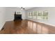Bright living room with fireplace, hardwood floors, and large windows overlooking a wooded area at 4294 Silver Peak Pkwy, Suwanee, GA 30024
