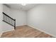 Spacious living room featuring hardwood flooring and staircase with iron balusters offers a blend of style and functionality at 4294 Silver Peak Pkwy, Suwanee, GA 30024