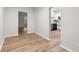 Open living area showcasing wood-look flooring and views into the kitchen and another room at 4294 Silver Peak Pkwy, Suwanee, GA 30024